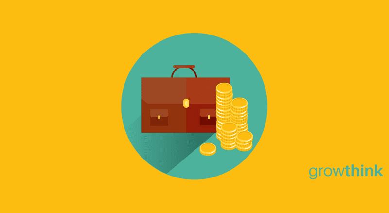 Brown briefcase with a stack of gold coins beside