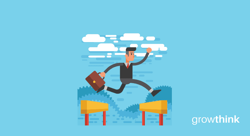 businessman holding a briefcase jumping over hurdles