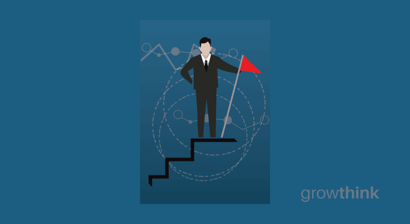 businessman on top of a stairs holding a red flag