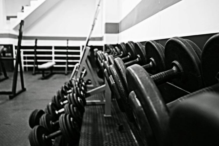 Stack of black dumbbells in a gym