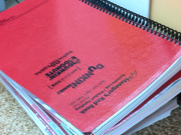 pile of Manager's Red Book at Dunkin Donuts