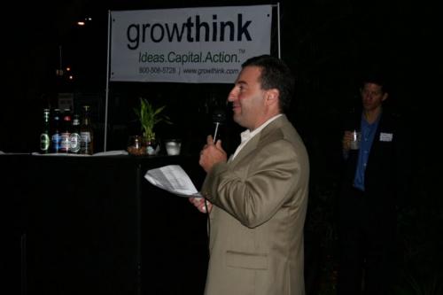 Jay Turo holding a mic and giving a speech