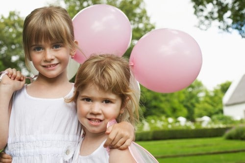 children holding balloons