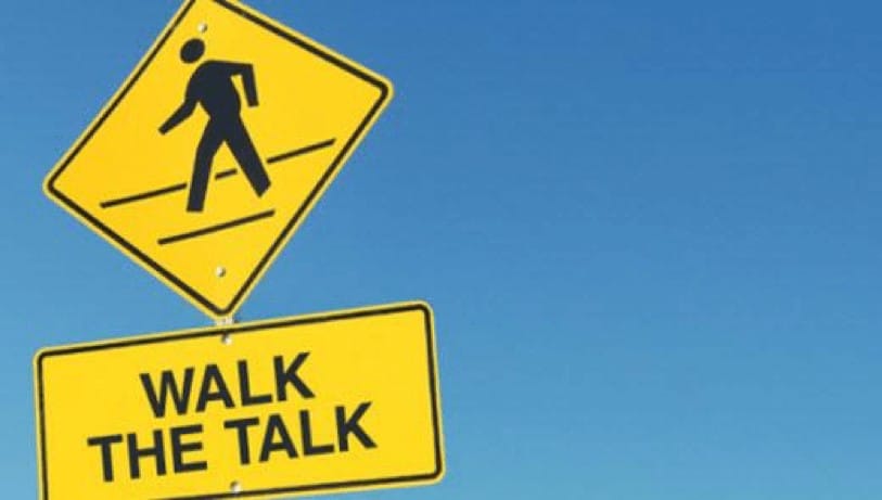 walk the talk road sign